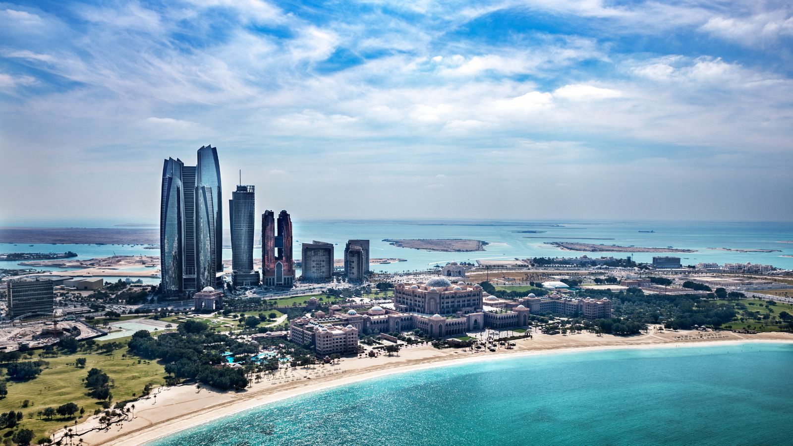 Abu Dhabi coastline with skyscrapers and luxury hotels.