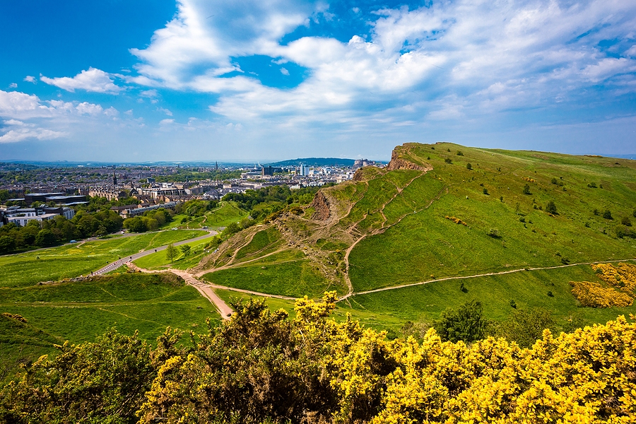 Cityscape of Edinburgh seen from Arthur’s Seat on summer day.