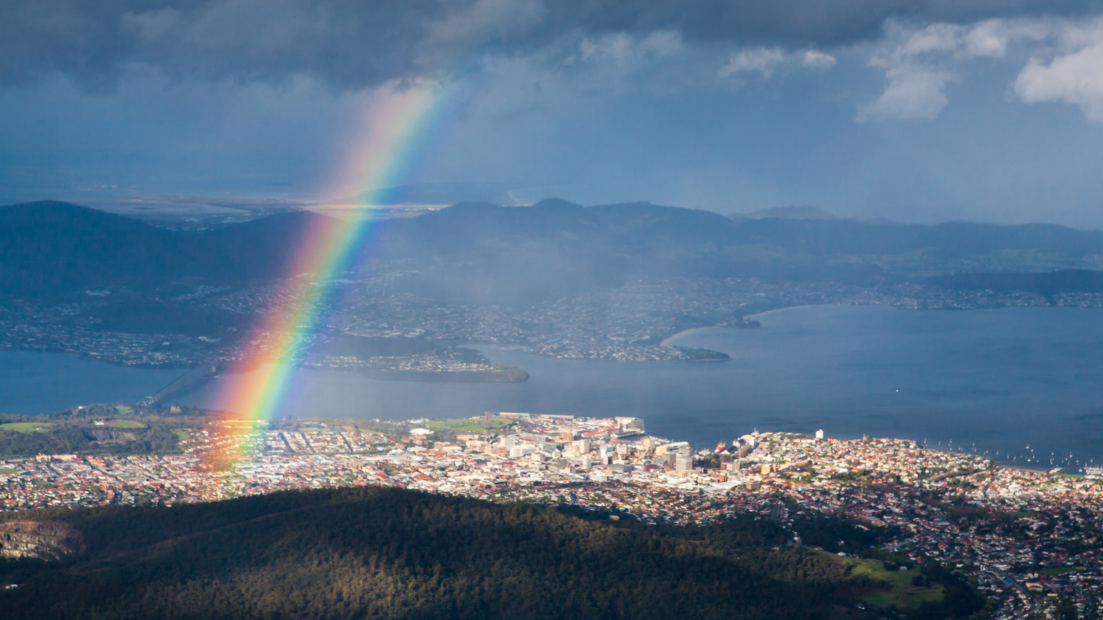 Aerial view of Hobart with a rainbow in the sky.