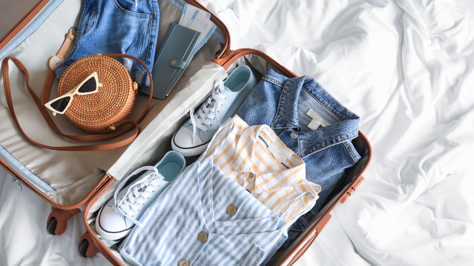 A packed suitcase lying open on a bed.