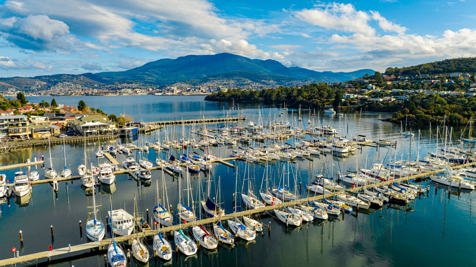 Yachts moored at Bellerive Pier in front of Mount Wellington.