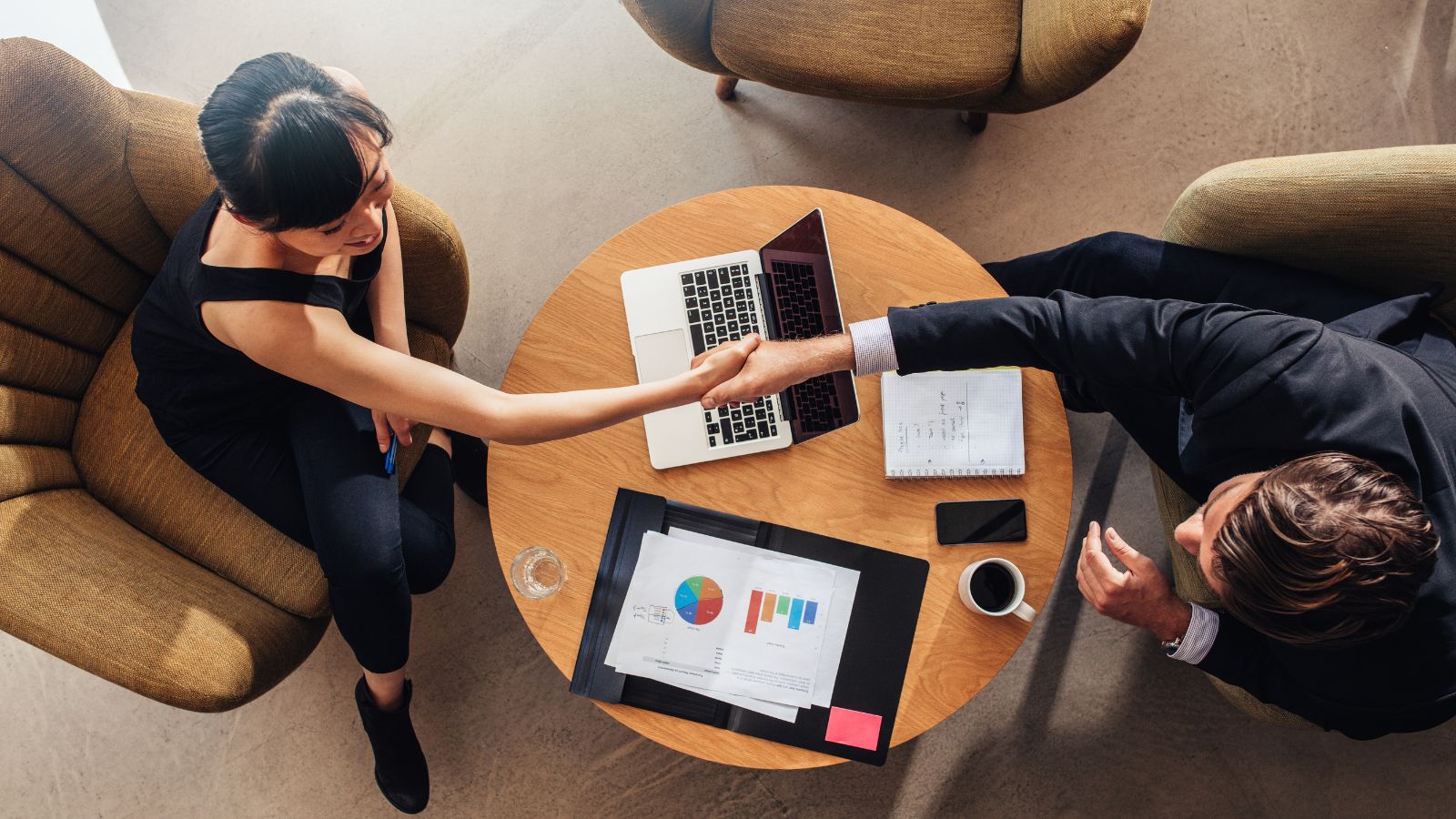 Aerial view of a man and a woman shaking hands.